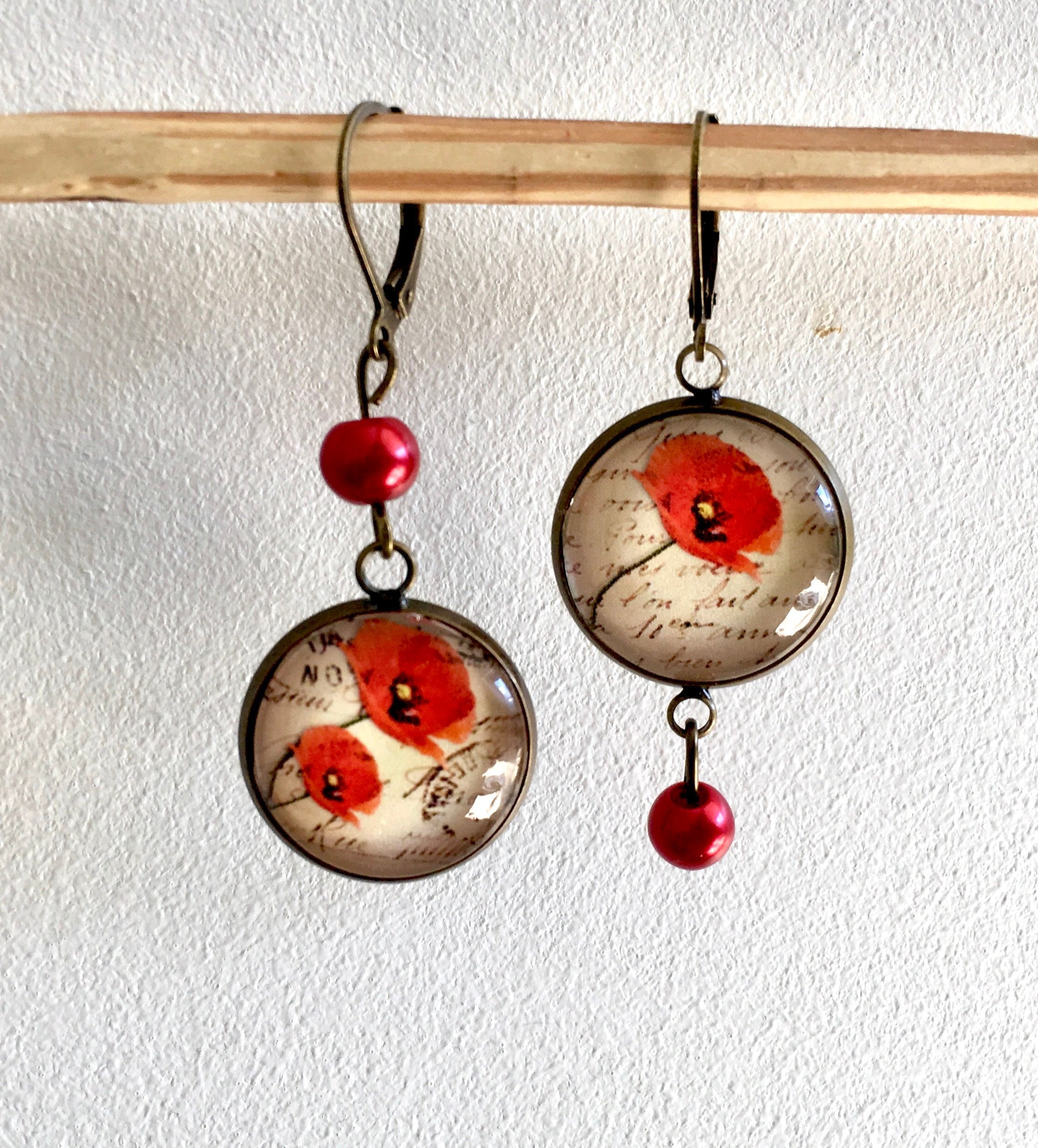 Asymmetrical earrings poppies and romantic vintage writings, dying in…