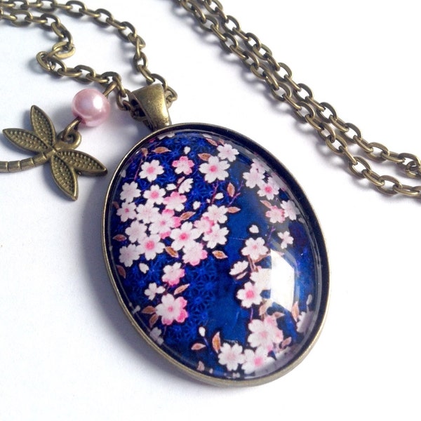 Collana lunga collana ovale cabochon fiori di ciliegio su fondo blu, libellula e perla rosa, in bronzo.