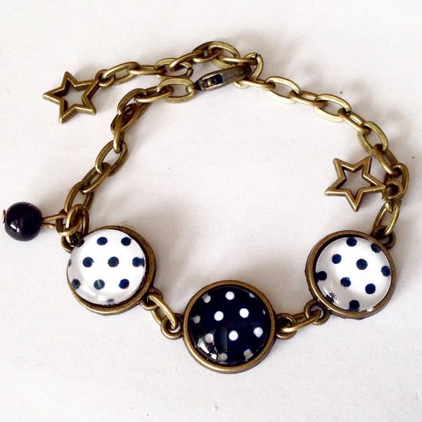 Bracelet ajustable, cabochons, en bronze et verre, pois noir et blanc, étoiles et perle.