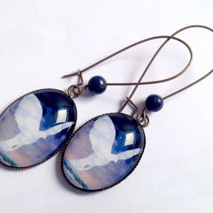 Dangling earrings, oval cabochons, Magritte's dove, lapis lazuli beads.