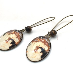 Oval earrings, cabochons, Gustave Klimt's mother and child, tiger eye beads.