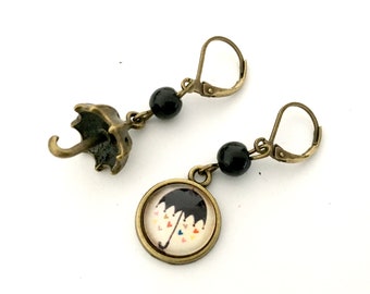 Small mismatched dangling umbrella earrings and black pearls.