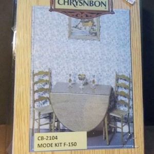 May include: A wooden dollhouse furniture kit by Chrysnbon, model CB-2104, Mode Kit F-150. The kit includes a round table and two chairs. The kit is packaged in a clear plastic bag with a price tag of $14.95.