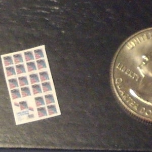 May include: Two sheets of postage stamps with a blue, white, and red design. Each sheet has 25 stamps.