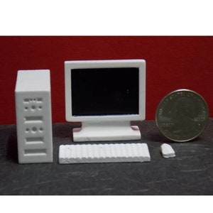 May include: White miniature desktop computer set with a monitor, keyboard, and tower. The set is about the size of a US quarter.