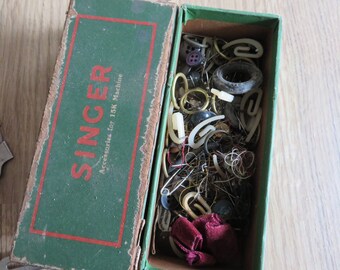 Quantity of Vintage Singer sewing machine attachments. As found.