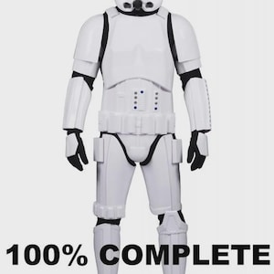 May include: A full-body, white Stormtrooper costume with black accents. The costume includes a helmet, chest armor, and leg coverings. The text "100% COMPLETE" is displayed in black at the bottom of the image.