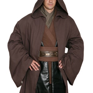 May include: A brown hooded robe with wide sleeves, a brown belt, and a black leather pouch. The costume includes a brown tunic and pants. The outfit is reminiscent of a Jedi or similar character.