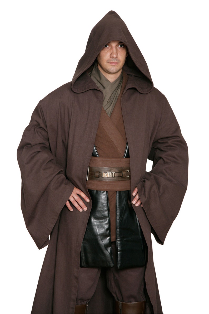 May include: A brown hooded robe with wide sleeves, a brown belt, and a black leather pouch. The costume includes a brown tunic and pants. The outfit is reminiscent of a Jedi or similar character.