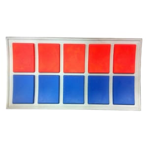 May include: A white rectangular panel with eight square buttons. The top row of buttons is red and the bottom row is blue.