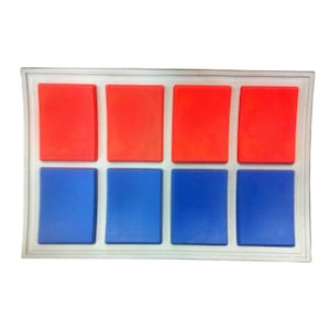 May include: A white rectangular patch with eight square buttons. The top row has four red buttons and the bottom row has four blue buttons.