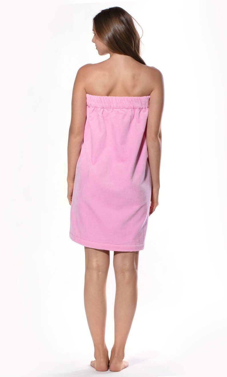 May include: A pink terry cloth wrap dress with a gathered waist.