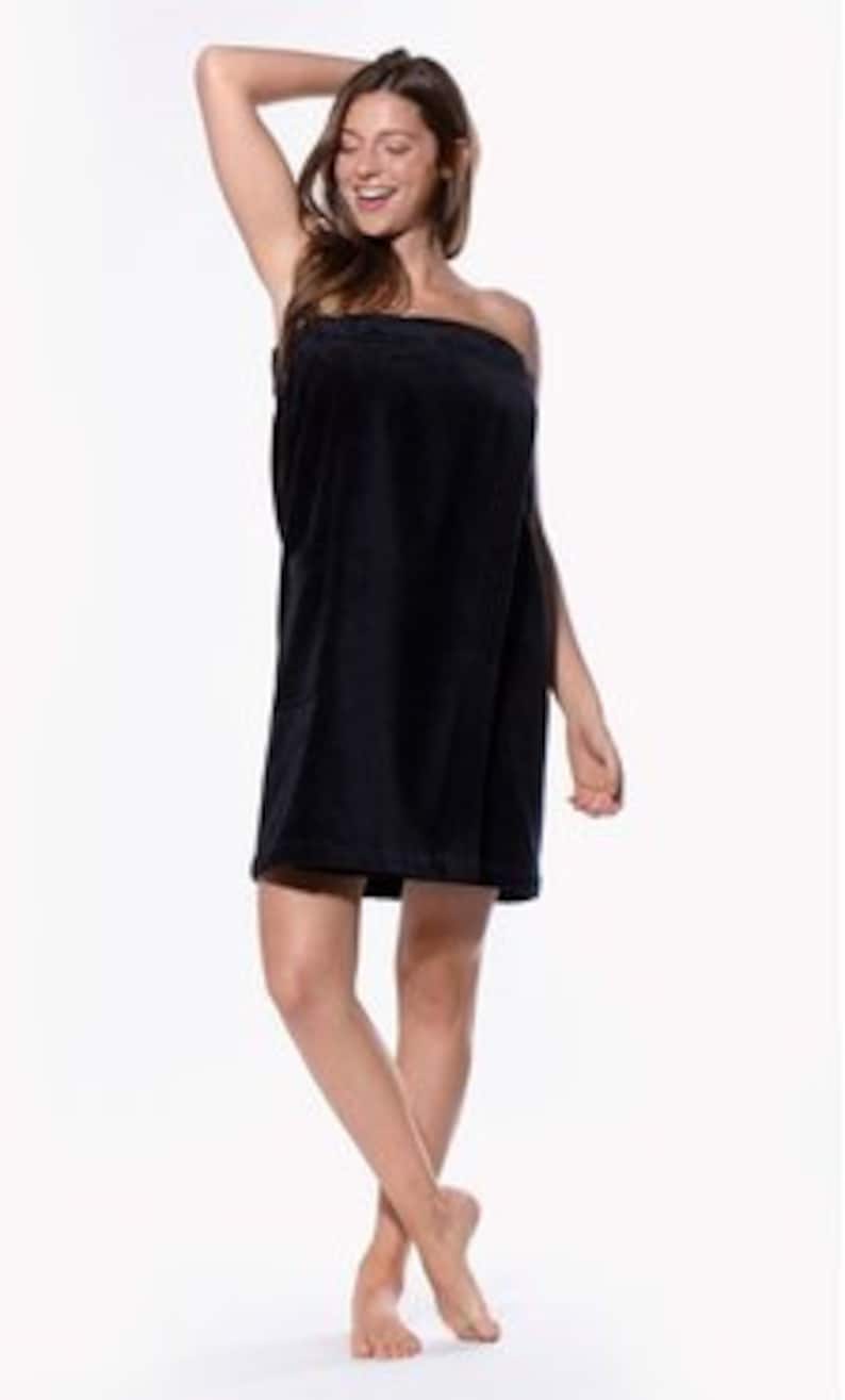 May include: Black wrap-around towel with a soft, plush texture. The towel is designed to be worn like a robe and has a simple, elegant style.