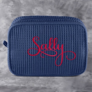 May include: A blue waffle-textured zippered pouch with the name "Sally" embroidered in red.