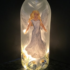 1.5 Ltr Lighted Clear Wine Bottle / Heavenly Angel overlooking flowers