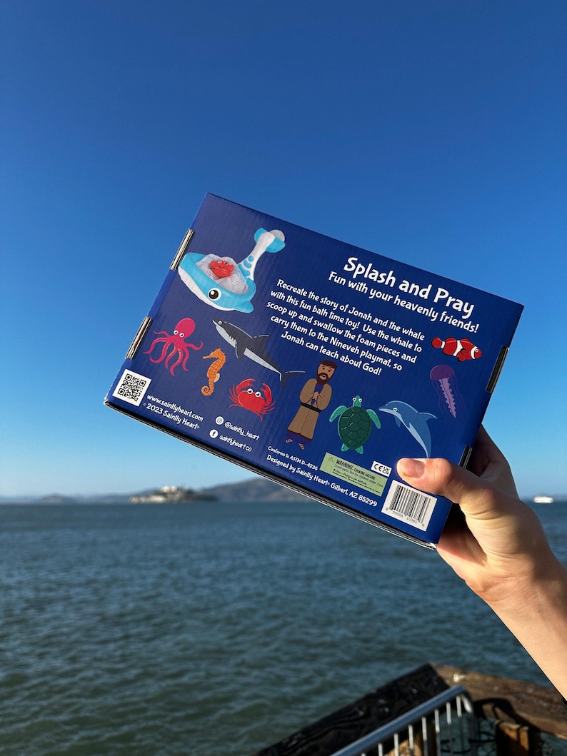 May include: Blue box with a whale, octopus, fish, seahorse, crab, turtle, and dolphin on it. The box is for a bath toy set that recreates the story of Jonah and the whale. The text on the box reads "Splash and Pray Fun with your heavenly friends!"