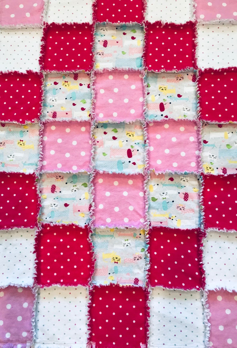 pink baby blanket with white polka dots