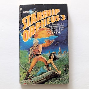 May include: A vintage paperback book titled "Starship Orpheus #3" by Symon Jade. The cover art features a man in orange and a woman in blue, with a planet and futuristic city in the background. The book's subtitle is "Alter Evil."