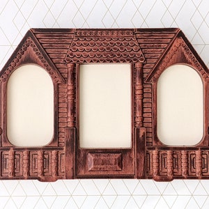 May include: A brown, multi-opening picture frame with a textured finish resembling wood grain. The frame features three distinct openings: two arched side windows and one rectangular center window, all framed by architectural details.