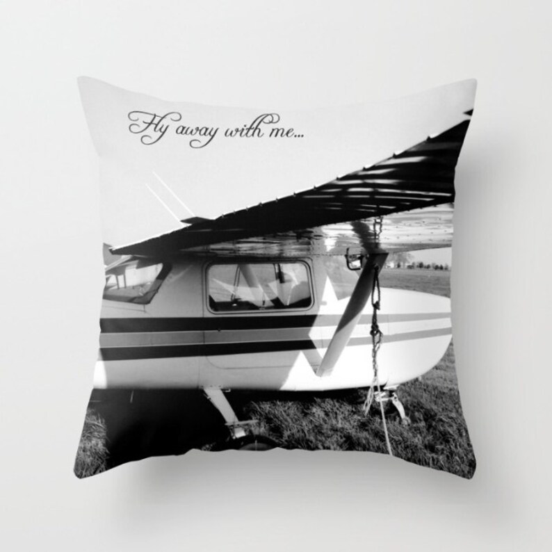 May include: Black and white photograph of a small airplane with the text "Fly away with me..." printed on the top of the image.