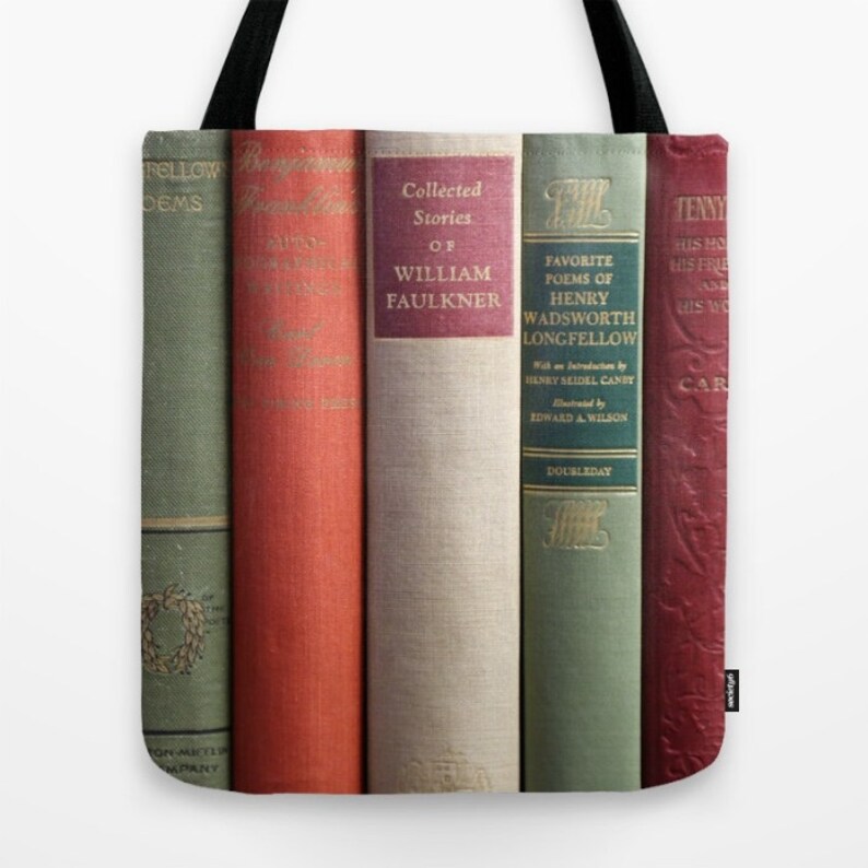 May include: Tote bag featuring a row of vintage books with titles including "Collected Stories of William Faulkner" and "Favorite Poems of Henry Wadsworth Longfellow." The books have various colors, including green, red, and beige, with gold lettering.