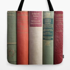 May include: Tote bag featuring a close-up of vintage book spines. The books have titles like "Collected Stories of William Faulkner" and "Favorite Poems of Henry Wadsworth Longfellow." The spines are in various colors, including green, red, and beige.
