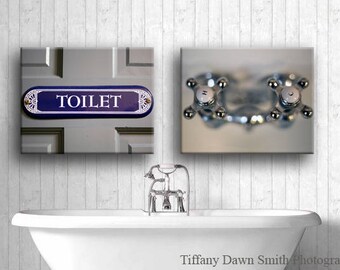 May include: Bathroom wall art featuring a blue and white "TOILET" sign and a close-up of chrome faucet handles. A white bathtub is in the foreground. The image has a vintage aesthetic.