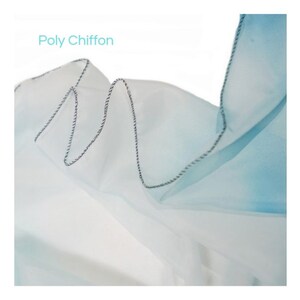 May include: Close-up of a light blue and white ombre poly chiffon fabric with a black and white stitched edge. The fabric is soft and sheer, and the ombre effect is subtle.