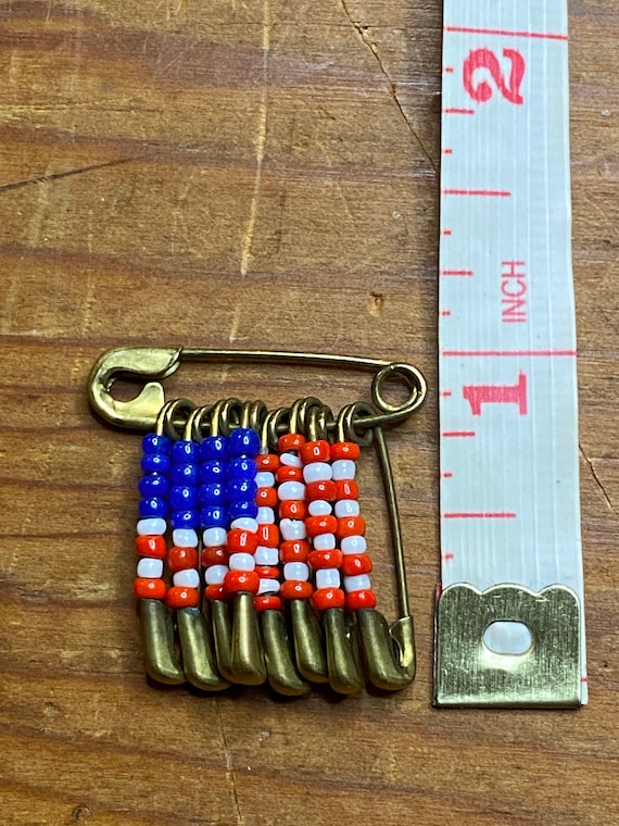 Patriotic safety pin and bead pin.