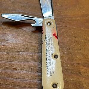Pocket knife with farm advertising
