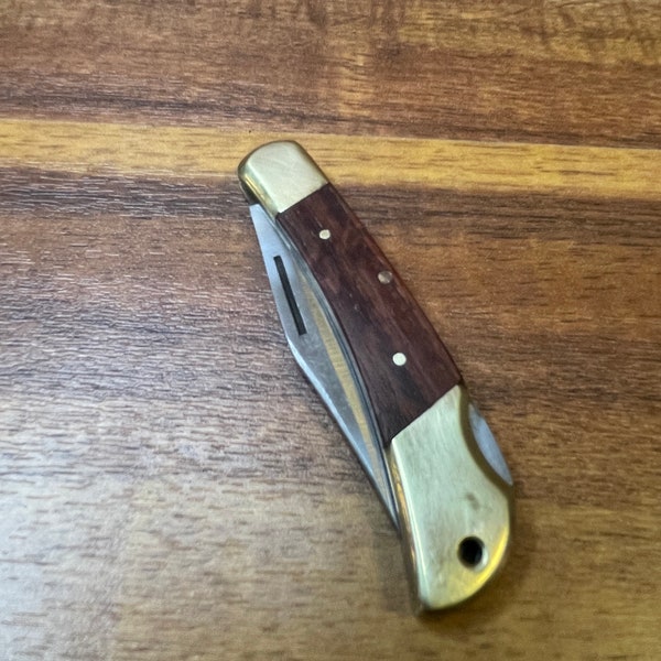 Pocket knife with wood sides and brass ends