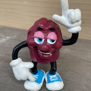 California raisin blue sneakers pointing towards sky