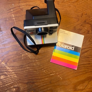 One Step Polaroid Land Camera with original instructional booklet