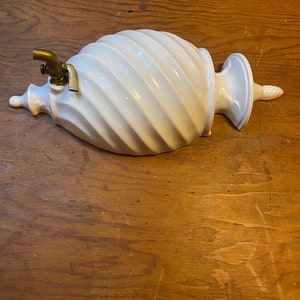 Ceramic wall water sconce with brass spigot.