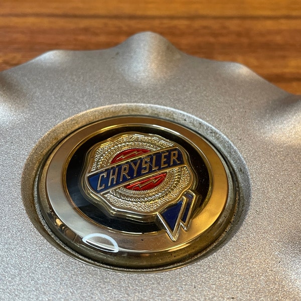 Chrysler hubcap insert unknown year Fun dispay for the car collector possibly a Sebring hubcap insert