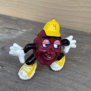 California Raisin Kid wearing Yellow roller skates and a yellow Hat with an H on it.