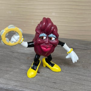 California Raisin Girl wearing Yellow High Heels and shaking Tamborine