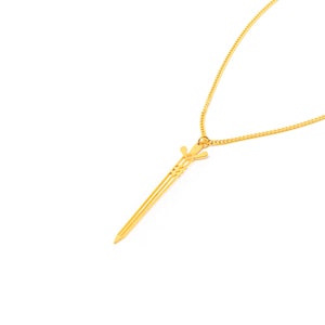 May include: A gold chain necklace with a sword pendant.
