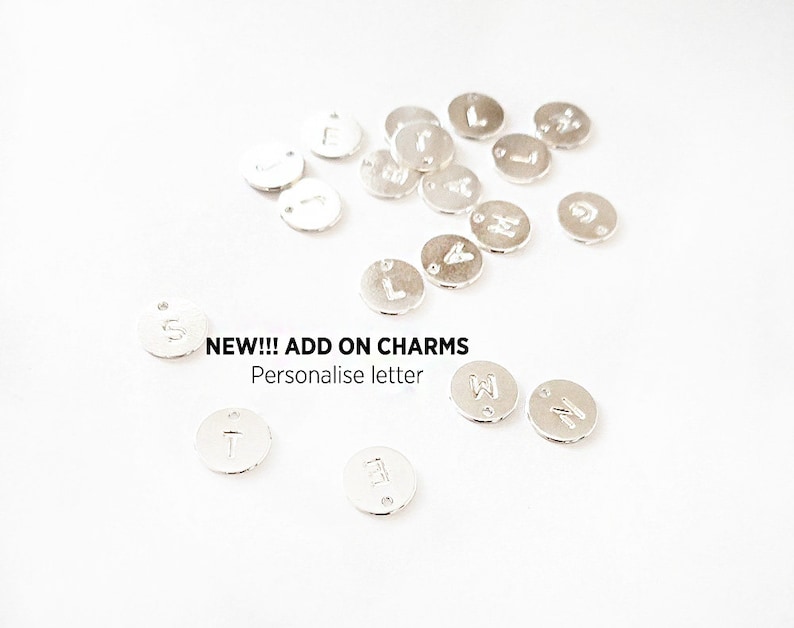May include: Silver letter charms for jewelry making.  NEW!!! ADD ON CHARMS Personalise letter