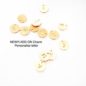 May include: Gold-coloured metal letter charms with a variety of letters, including A, B, C, J, M, P, T, and V.  NEW!!! ADD ON Charm Personalise letter
