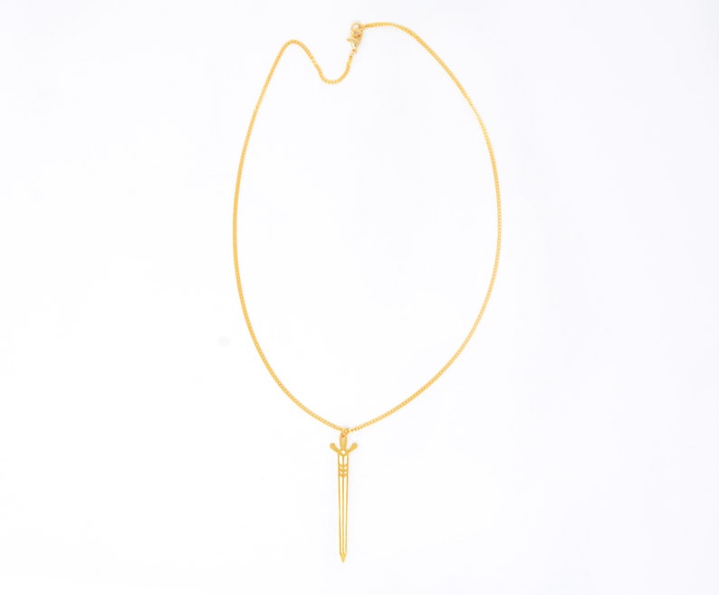 May include: A gold chain necklace with a sword pendant.