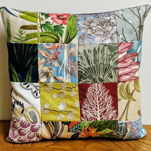 May include: A patchwork pillow cover featuring a range of floral and botanical designs in shades of green, blue, red, and yellow.