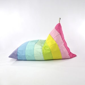 May include: A rainbow-colored bean bag chair with a quilted design. The chair is made of a soft, durable fabric and is perfect for lounging or reading.