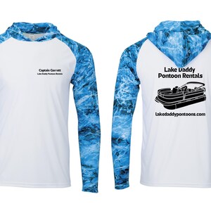 May include: White hooded long-sleeve shirt with blue marbled sleeves and hood. The front has the text "Captain Garrett Lake Daddy Pontoon Rentals". The back features a pontoon boat graphic and the text "Lake Daddy Pontoon Rentals" and "Lakedaddypontoon.com".