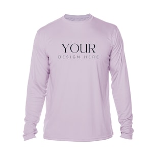 May include: A long-sleeved, light purple shirt with the text "YOUR DESIGN HERE" printed in black. The shirt has a crew neck and is made of a lightweight material, suitable for various activities.