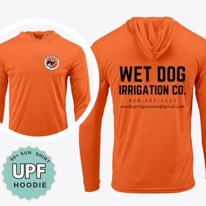 May include: An orange long-sleeve hoodie with a circular logo on the front chest featuring a dog illustration. The back displays the black text WET DOG IRRIGATION CO. with the phone number 608-501-1225 and email address wetdogirrigationco@gmail.com.