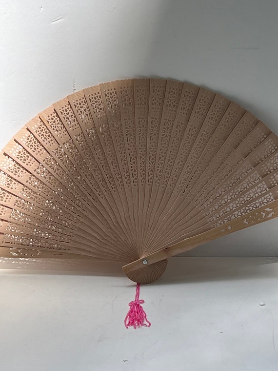 vintage dime store wooden fan with tassel.