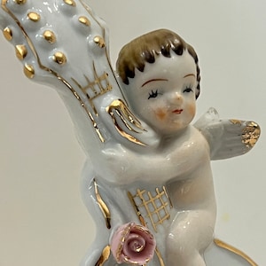 Vintage dime store ceramic musical cherub with cello miniature vase.