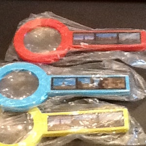 1970’s New York City tourist souvenirs magnifying glasses featuring world trade center picture.