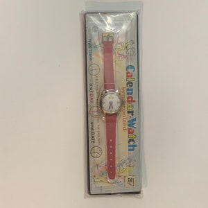 Vintage dime store kids tin toy Calendar watch synchronized on original card.